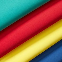 an assortment of different colors of fabric, including blue, yellow, red and green