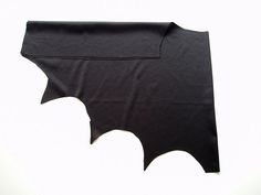 a bat shaped piece of black fabric on a white background