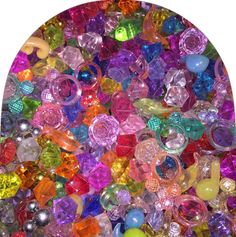 many different colored glass beads are scattered together