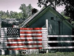 an american flag painted on the side of a house