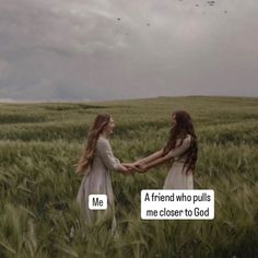 two girls in a field holding hands with the words me friend who pulls me closer to god