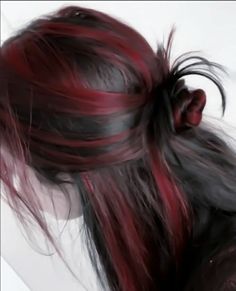 a woman with red and black hair is shown from the back