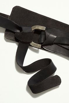 Add some edge to your outfit with this so cool leather waist belt featured in a wide, asymmetric style with a wrap closure and rounded pull-through buckle.* Adjustable design* Meant to be worn on the natural waist