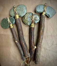 some rocks and sticks are arranged on a leather surface