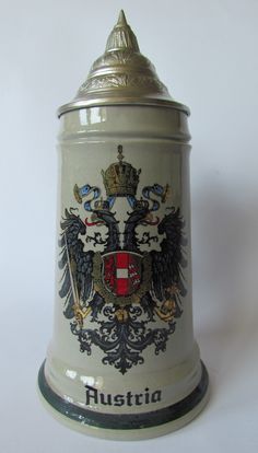 an old german beer mug with two headed eagle and the word austria on it's side