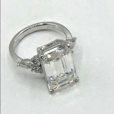 an emerald cut diamond ring with three side stones