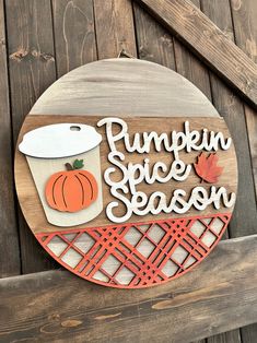 a wooden sign that says pumpkin spice season with a cup of coffee on the front