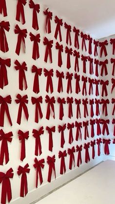 the wall is decorated with red bows and ribbons, all over it's surface