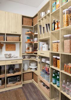 an organized pantry with lots of food in baskets and containers on shelving units,