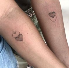 two people with matching tattoos on their arms