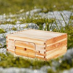 a wooden box sitting in the grass