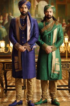 two men dressed in green and gold standing next to each other