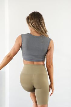 Embrace the sweat in this supportive Eva Essential Cropped Top. Sleek, soft and comfortable meets function in this workout top. Be confident during your next sweat sesh knowing you're covered. This sleeveless top has a cropped hem and high neck. Model is 5’5” wearing a size small Total Length of a small is 13.5" 72% Nylon, 28% Lycra Functional Seamless Crop Top, Gray High-stretch Yoga Top, Supportive Casual Yoga Tops, Casual Supportive Tops For Yoga, Supportive Casual Tops For Yoga, Seamless Compression Sleeveless Top, Sporty Gray Stretch Crop Top, Supportive Seamless Tops For Athleisure, Medium Support Activewear Crop Top For Yoga