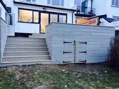 a house that has been built into the side of a hill with stairs leading up to it