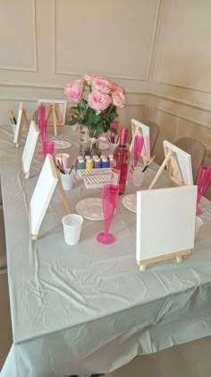 a table topped with pictures and pink flowers