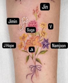 an image of a flower tattoo on the leg with names in english and japanese letters