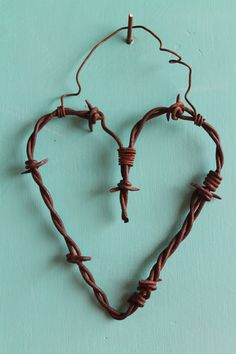 a heart shaped barbed wire on a blue background