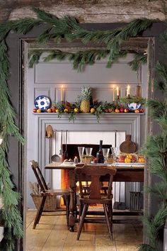 an open door leading into a dining room with christmas decorations on the mantle and table