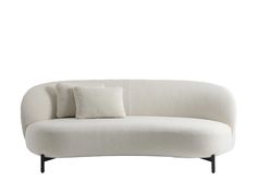 a white couch with two pillows on it's back and one pillow on the side