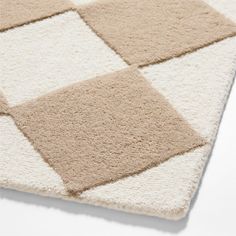 a beige and white rug with squares on the bottom, in different sizes and colors