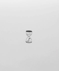 two hourglasses sitting on top of each other in front of a white wall