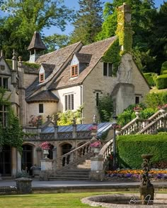 a large house with many windows and lots of greenery