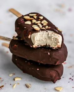 two ice creams stacked on top of each other with nuts and chocolate in them