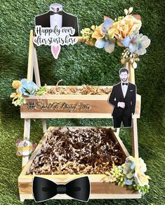 a wooden box filled with cake next to a sign that says happily wed so sweet