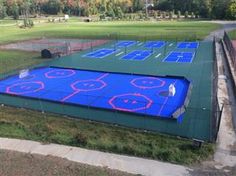 an overhead view of a tennis court with blue tarps and red lines on it