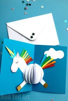 an open card with a paper unicorn on it