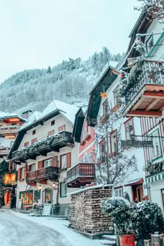 a snowy street lined with buildings and trees