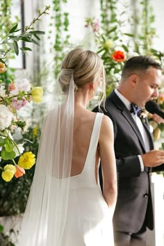 the bride and groom are standing at the alter