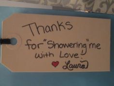 a white tag with writing on it that says thanks for showering me with love