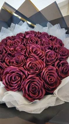 a bouquet of red roses sitting on top of a table