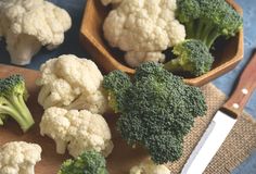 broccoli florets and cauliflower on a cutting board