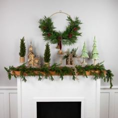 a mantel with christmas decorations on top of it