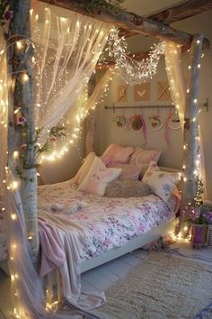 a bed with lights on the headboard and canopy over it