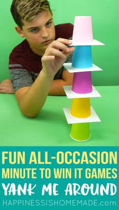 a young boy is playing with a tower made out of paper and the words fun all - occasion minute to win it games