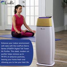 a woman sitting on the floor in front of an air purifier