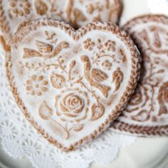 some heart shaped cookies are on a doily