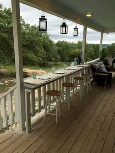 an image of a porch with chairs and table on the front porch, looking out over the water