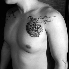 a shirtless man with a compass tattoo on his chest