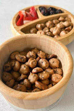 two wooden bowls filled with different types of food on top of a white countertop