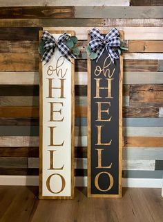 two wooden signs that say hello and hello, with bows on the front one is black and white