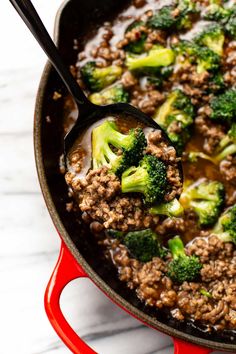 a skillet filled with ground beef and broccoli