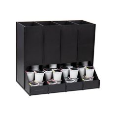 a set of six cups sitting on top of a black holder with compartments for each cup