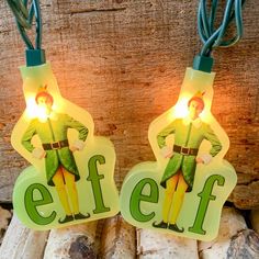 two christmas lights that have the words elf on them and an elf standing next to each other