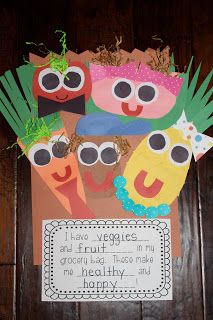 a paper bag with some fruit and vegetables cut out to look like they are wearing sunglasses