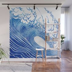 an ocean wave wall mural in a living room with wooden flooring and white walls