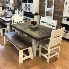 a wooden table with white chairs around it in a room filled with cabinets and other furniture